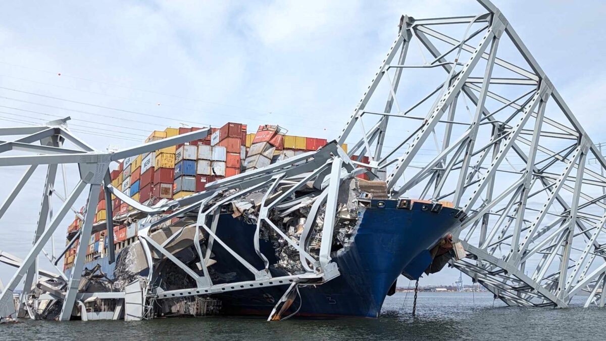 container ship at the base of collapsed bridge